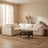 A sectional sofa and ottoman in a calm living room with warm plaster walls and a white oak floor
