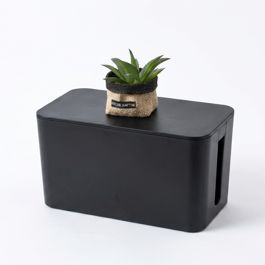 Black cable management box, white background
