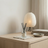 Clear reed diffuser on a wooden side table
