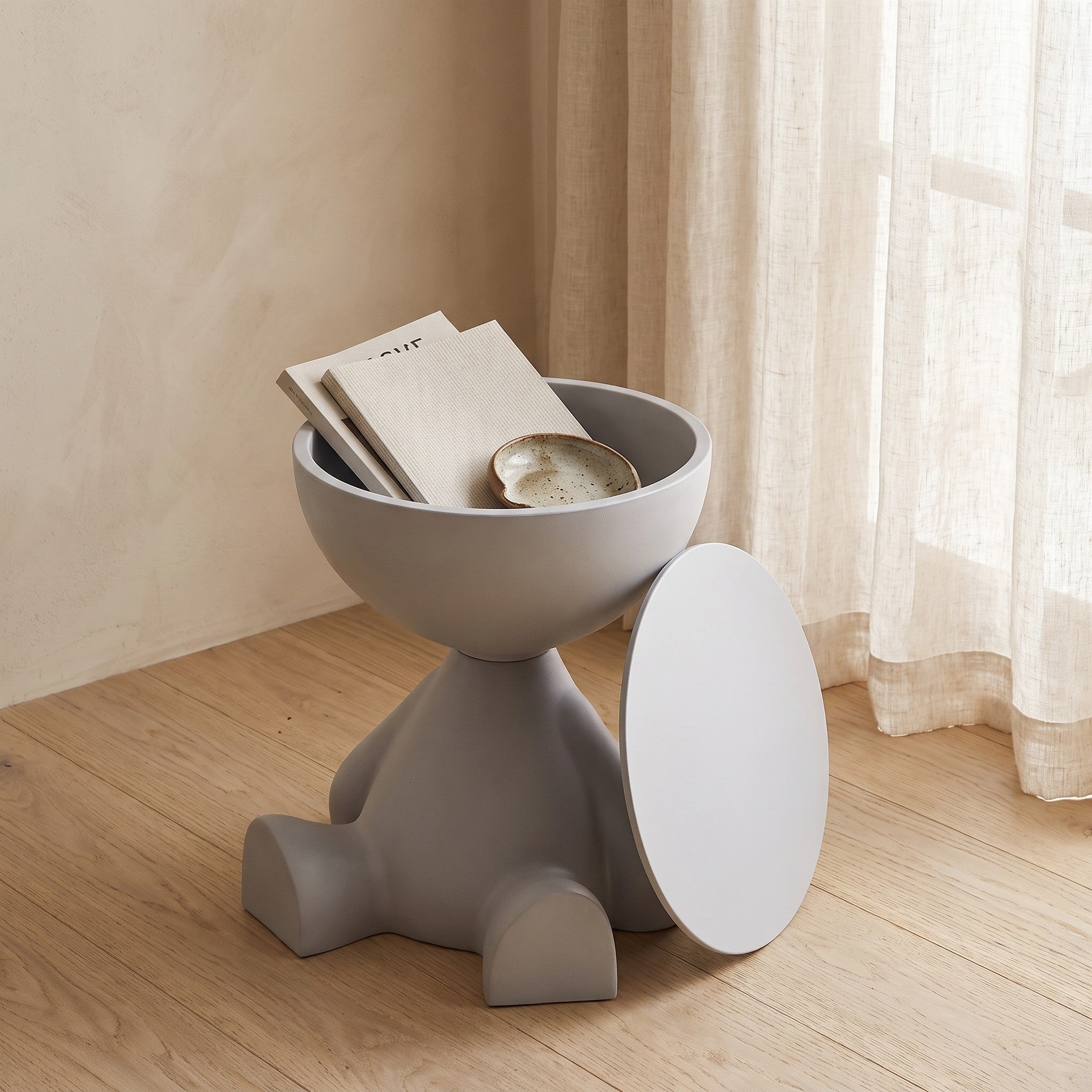 Bowl-top storage end table with its lid removed showing items stored inside