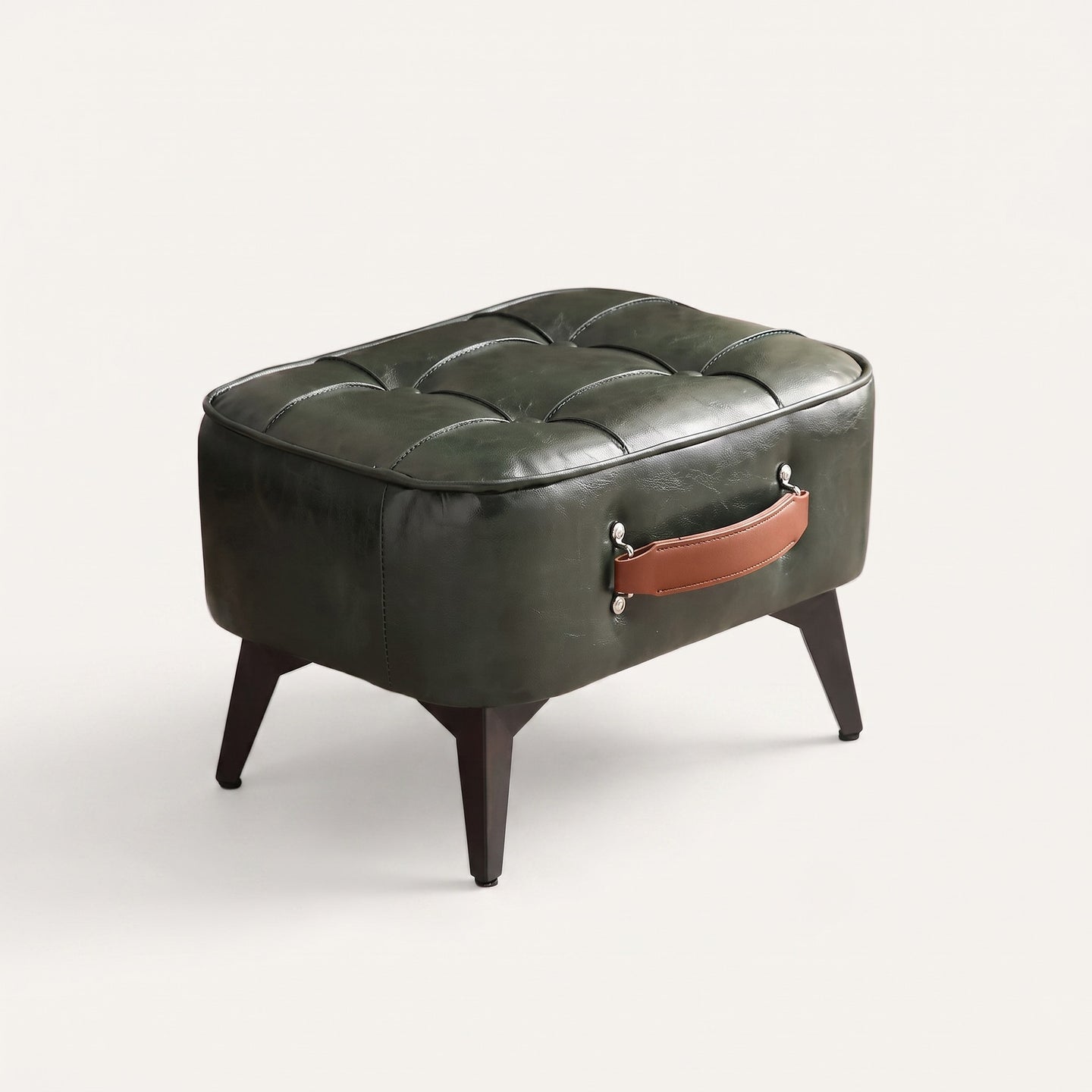 Tufted faux leather ottoman on white background