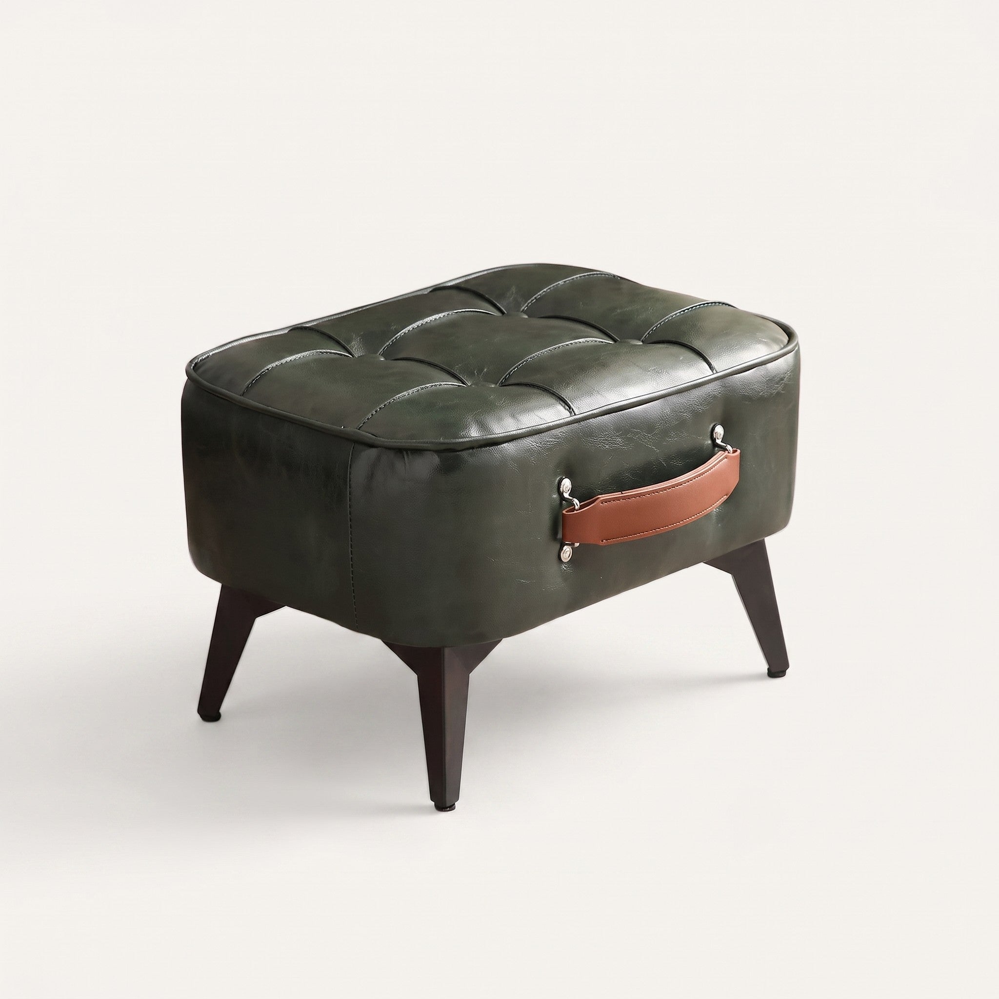 Tufted faux leather ottoman on white background