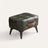 Tufted faux leather ottoman on white background