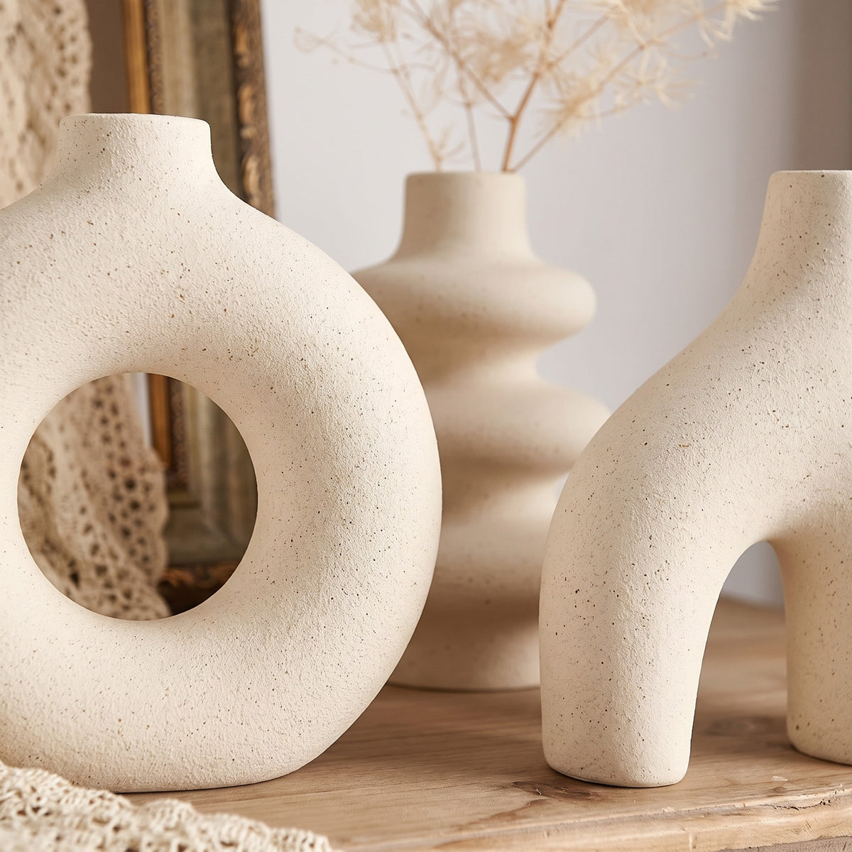 Close-up detail of sculptural ceramic vase trio texture