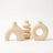 Sculptural ceramic vase in light yellow on white background