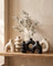 Sculptural ceramic vase trio styled on a console table scene