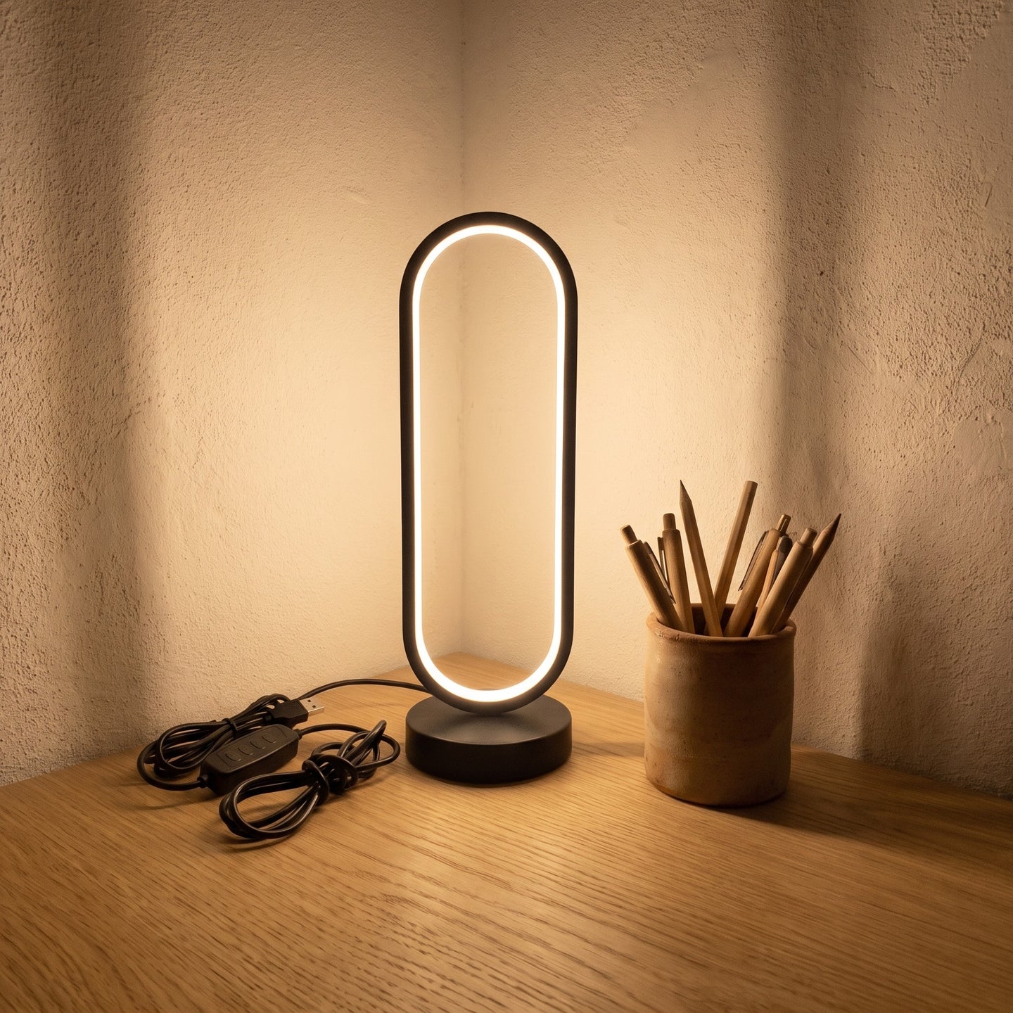Black oval ring desk lamp styled on a desk scene