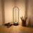 Black oval ring desk lamp styled on a desk scene