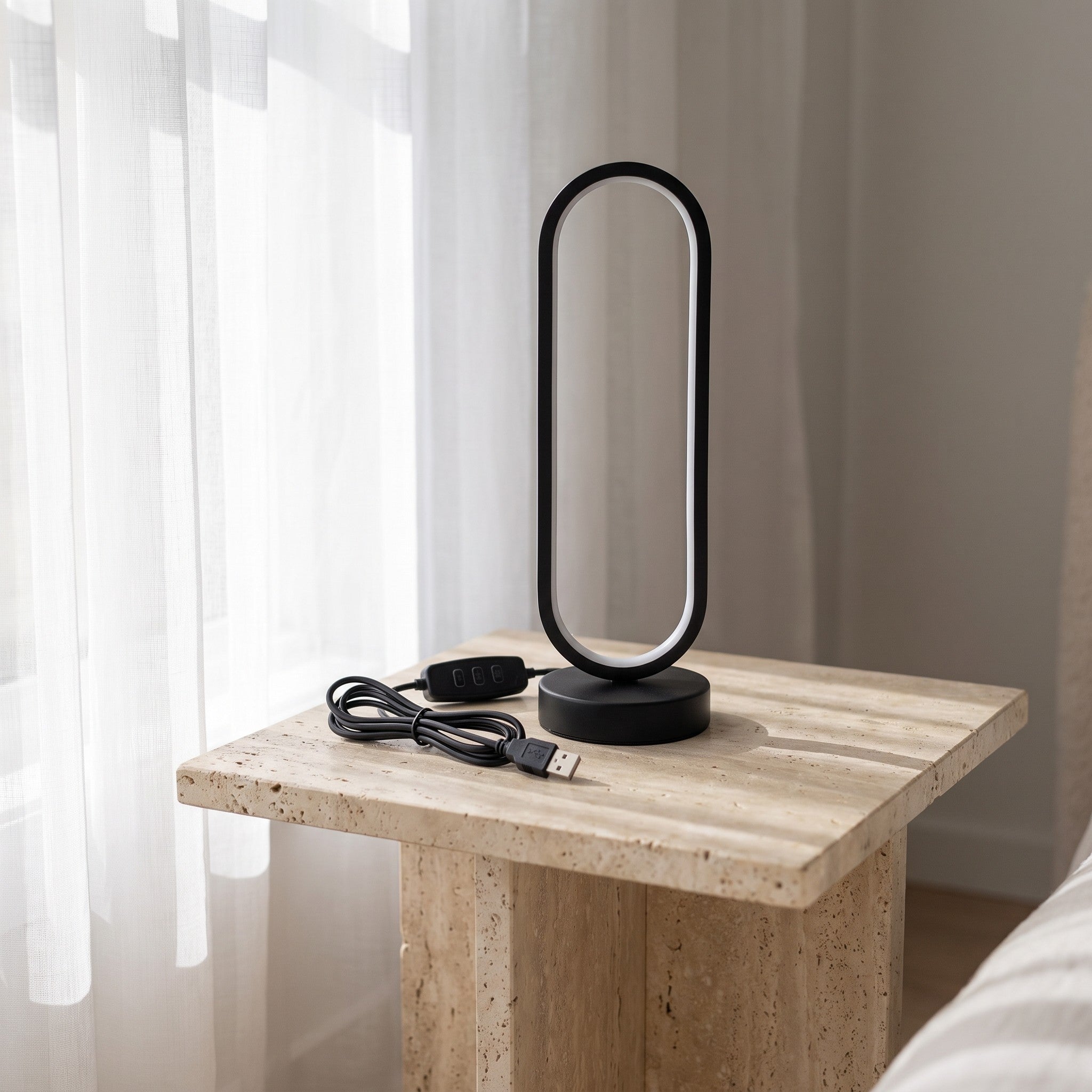 Black oval ring desk lamp styled on a nightstand scene