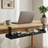 Wooden desk with laptop, mug, and books, featuring a power strip with cables underneath.