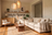 Living room with a white sofa, wooden coffee table, and 'Muto Space' branding.