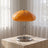 Chrome tripod glass dome lamp styled on a side table scene