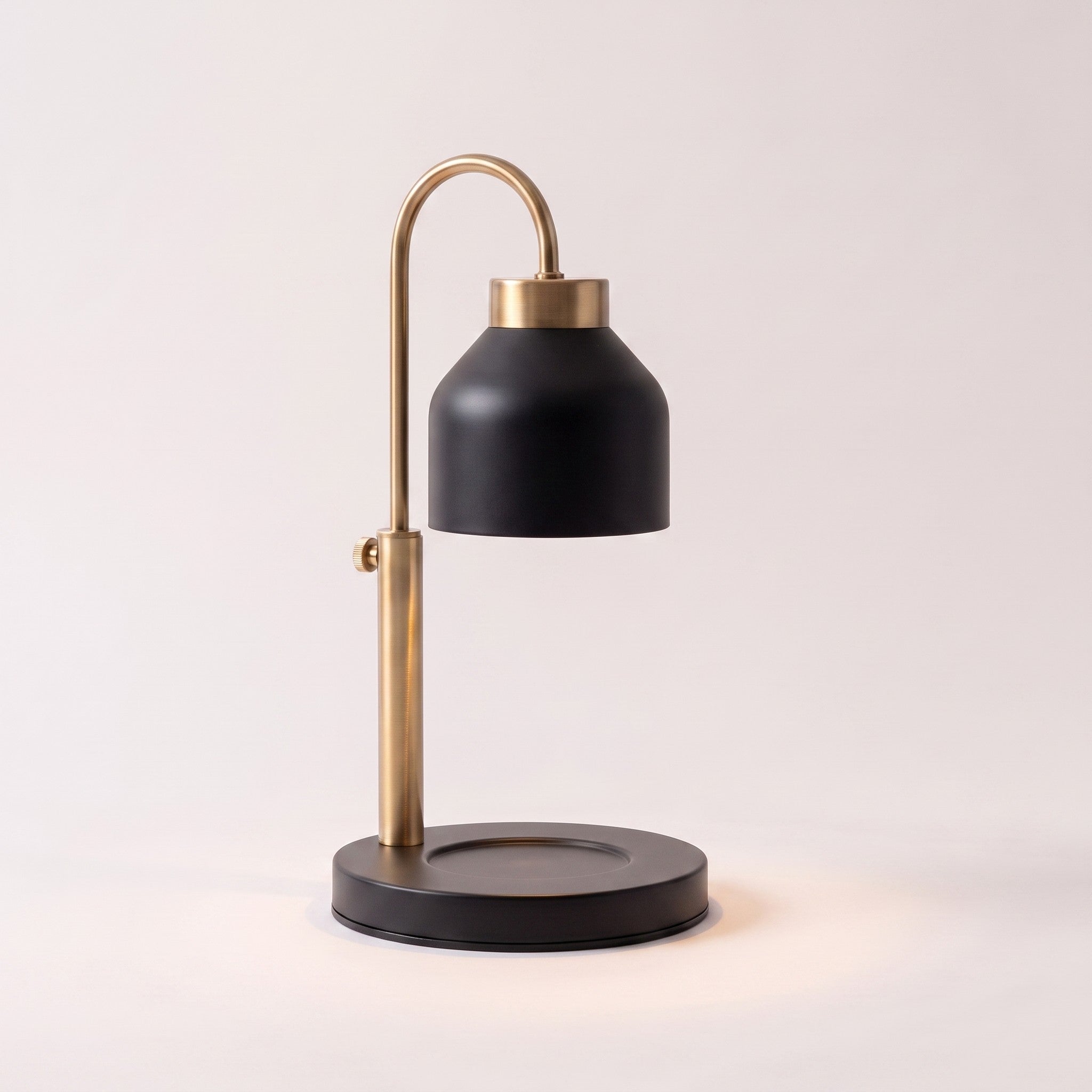 Dual-bulb candle warmer lamp in black shown alone with an empty base on a plain off-white background