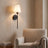 Black cordless fabric shade wall sconce in a reading nook scene