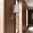 Gold cordless fabric shade wall sconce in a hallway scene
