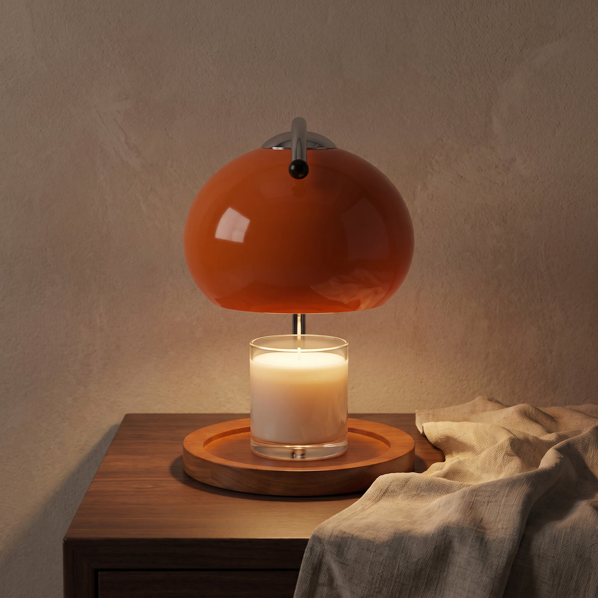 Glass candle warmer lamp lit over a jar candle on a walnut side table in evening light, candle not included
