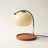 Glass candle warmer lamp in milky white, shown alone with an empty base on a plain off-white background