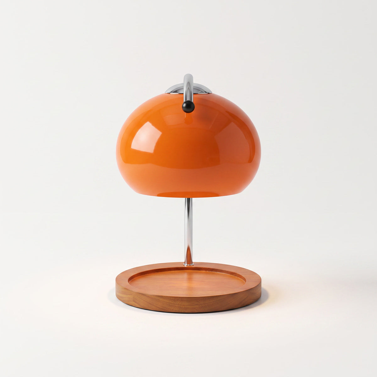 Glass candle warmer lamp in orange, shown alone with an empty base on a plain off-white background
