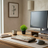 Modern home office desk with computer setup, plants, and decor.