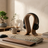 Modern desk setup with keyboard, mouse, and headphones on a wooden desk.