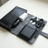 Close-up of the PU Leather Tech Organizer Case in black, opened flat showing the charger compartment, cable loops, and pen loop
