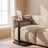 Height-Adjustable C-Shaped Side Table beside a linen sofa with a laptop resting on its tilted top