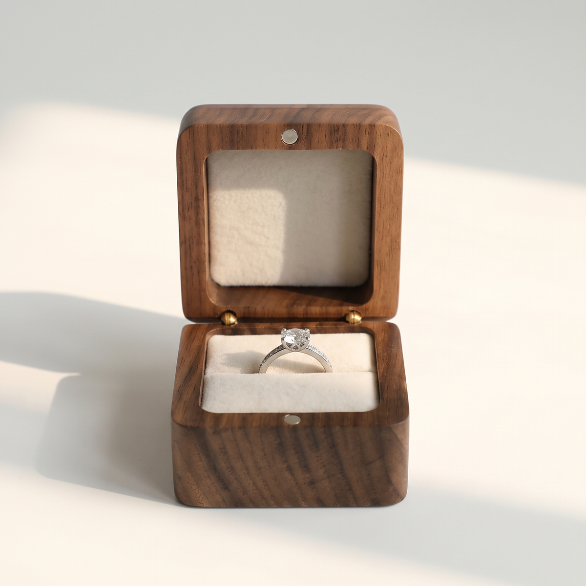 Wood Ring Box, Beige Interior, open on its hinge showing the velvet-lined interior with a ring
