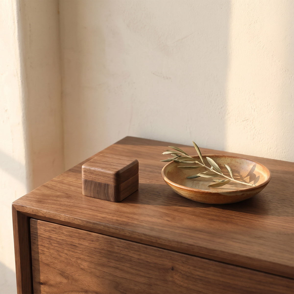 Wood Ring Box closed on a walnut dresser beside a ceramic dish and an olive branch