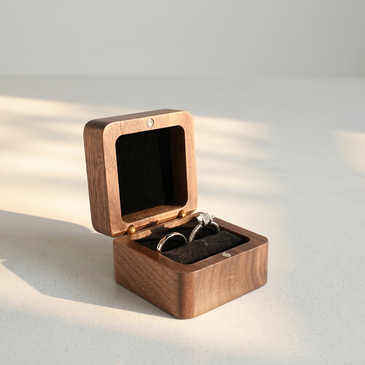 Wood Ring Box, Black Interior, open on its hinge showing the velvet-lined interior with a ring