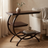 C-shaped 3-tier metal end table, chocolate finish, styled in a room scene