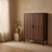Enclosed 5-tier shoe cabinet in brown finish, styled in a warm room setting