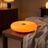 Frosted Donut Table Lamp, Orange, lit room scene