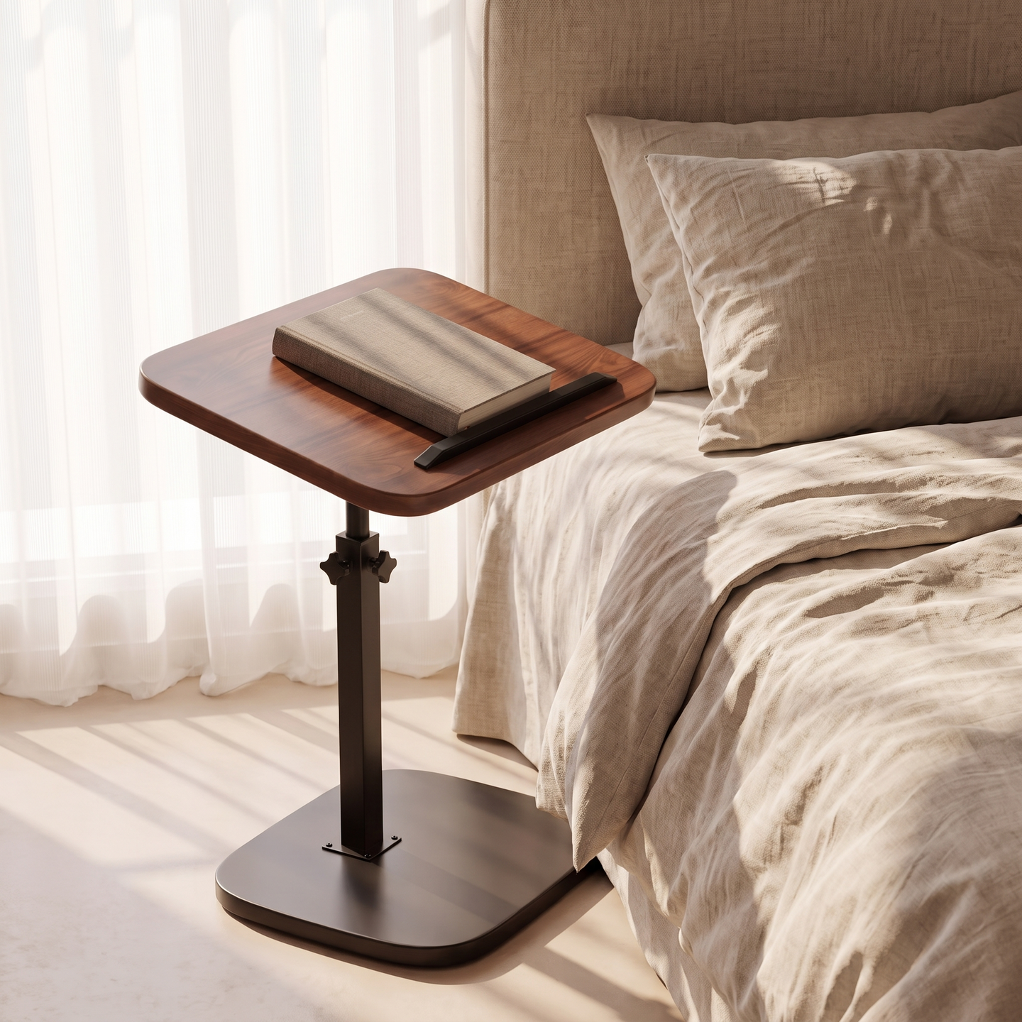 Height-Adjustable C-Shaped Side Table beside a bed with a book on the tilted top