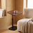 Height-Adjustable C-Shaped Side Table beside an accent chair with a mug on the tilted top