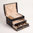 Arched three-layer jewelry box, black finish, lid open showing three sorting layers with rings, earrings, and a necklace