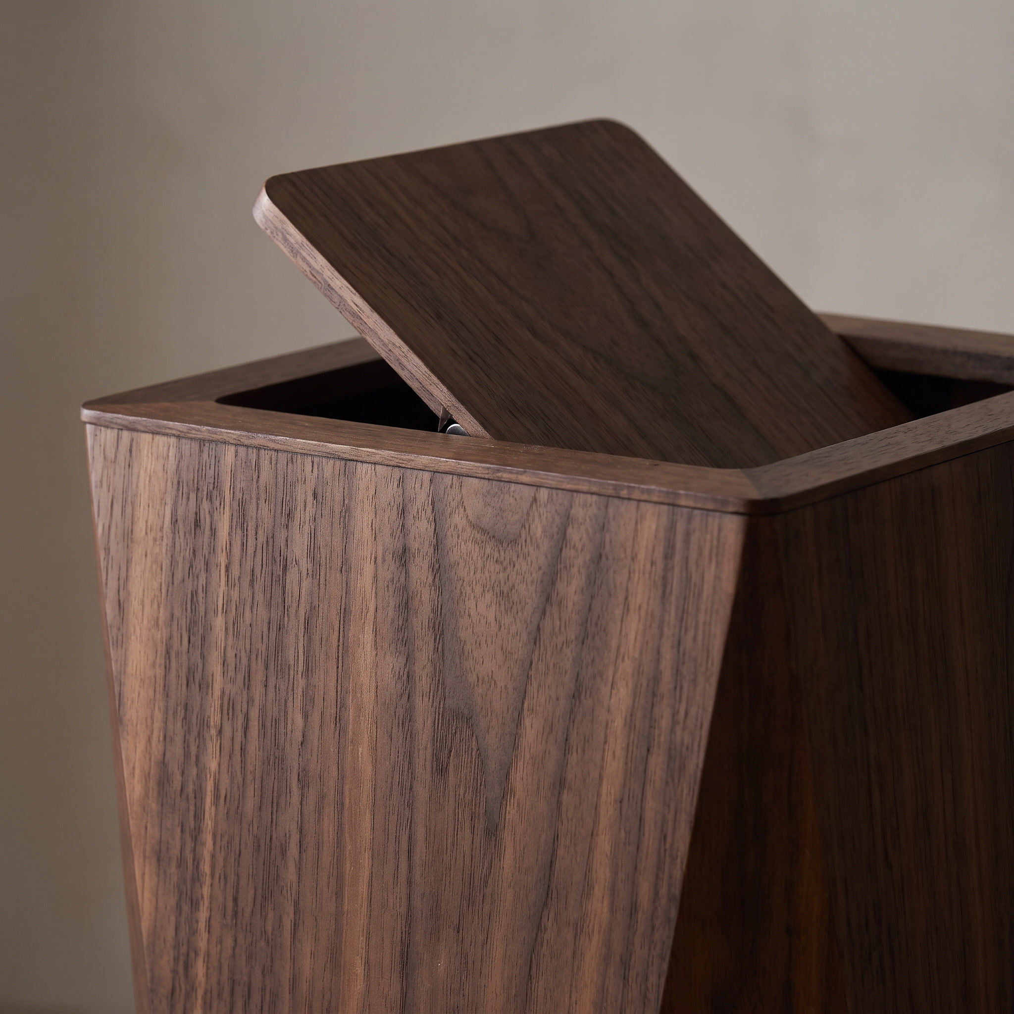 Close detail of the bin's flap lid mechanism, walnut finish