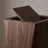Close detail of the bin's flap lid mechanism, walnut finish
