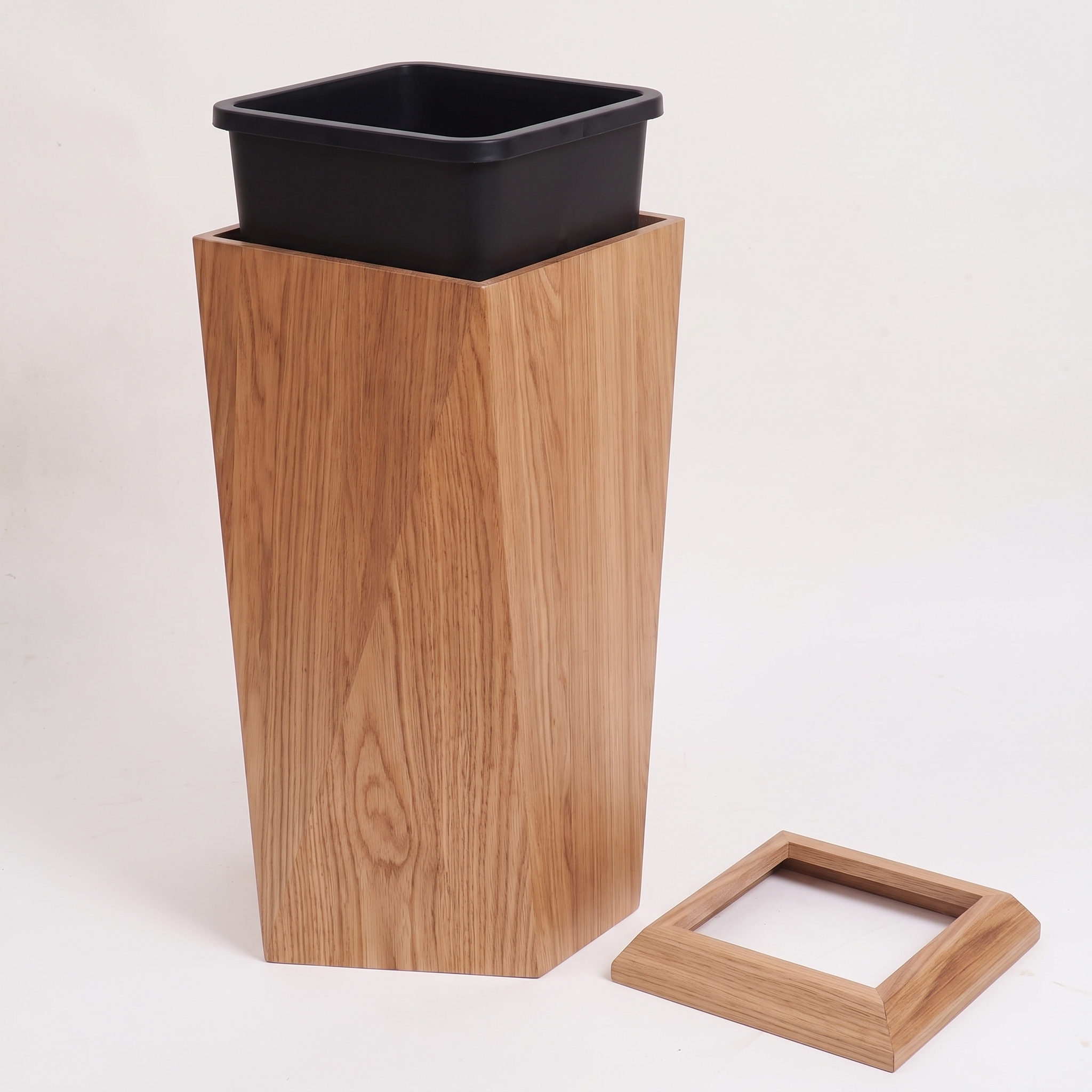 Tapered square waste bin with its wood rim lifted off, showing the removable liner bucket inside