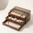 Warm Wood-Grain Tiered Jewelry Box with all three drawers pulled part way open, showing the soft lining inside each.