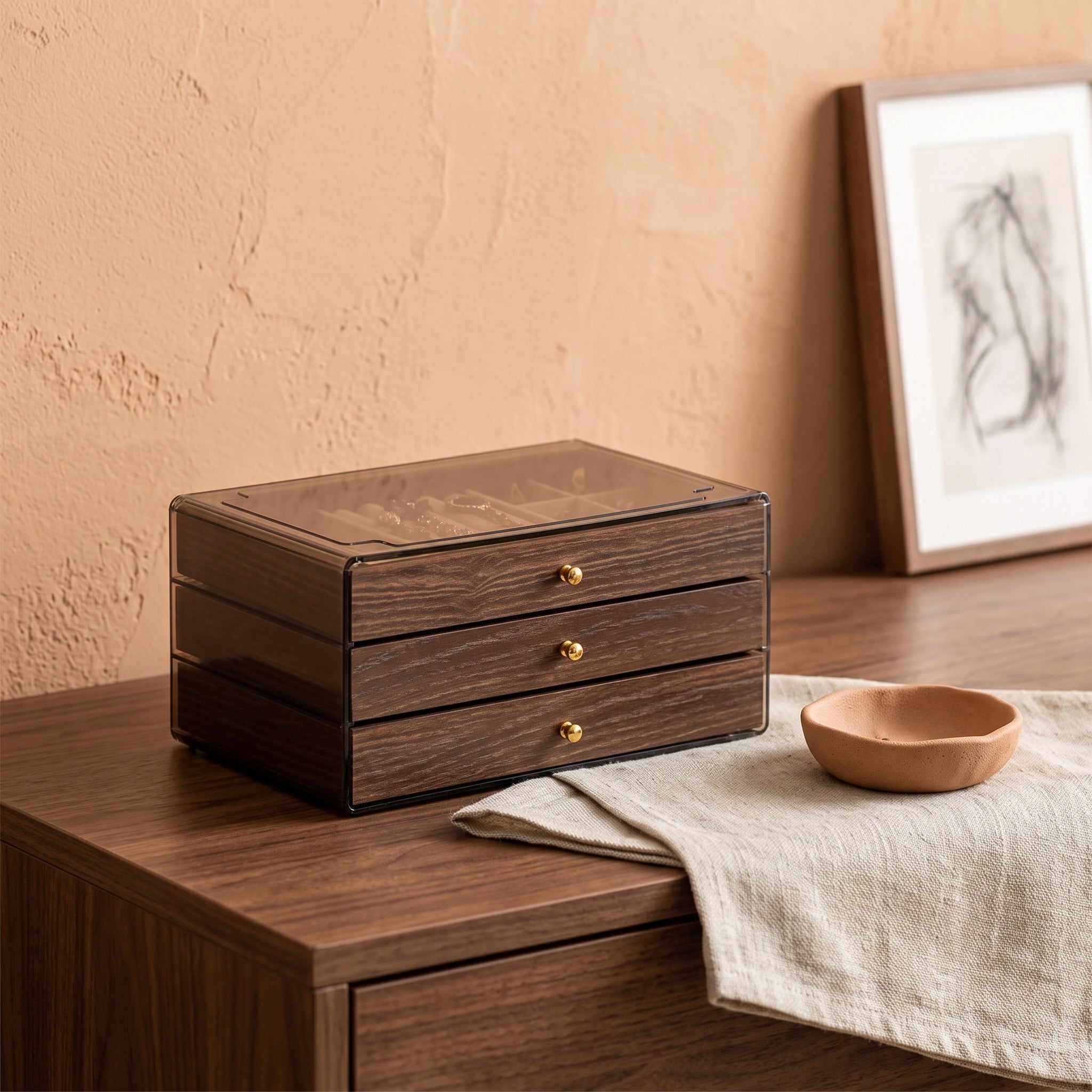 Warm Wood-Grain Tiered Jewelry Box closed on a walnut dresser beside a ceramic dish and a folded linen runner.