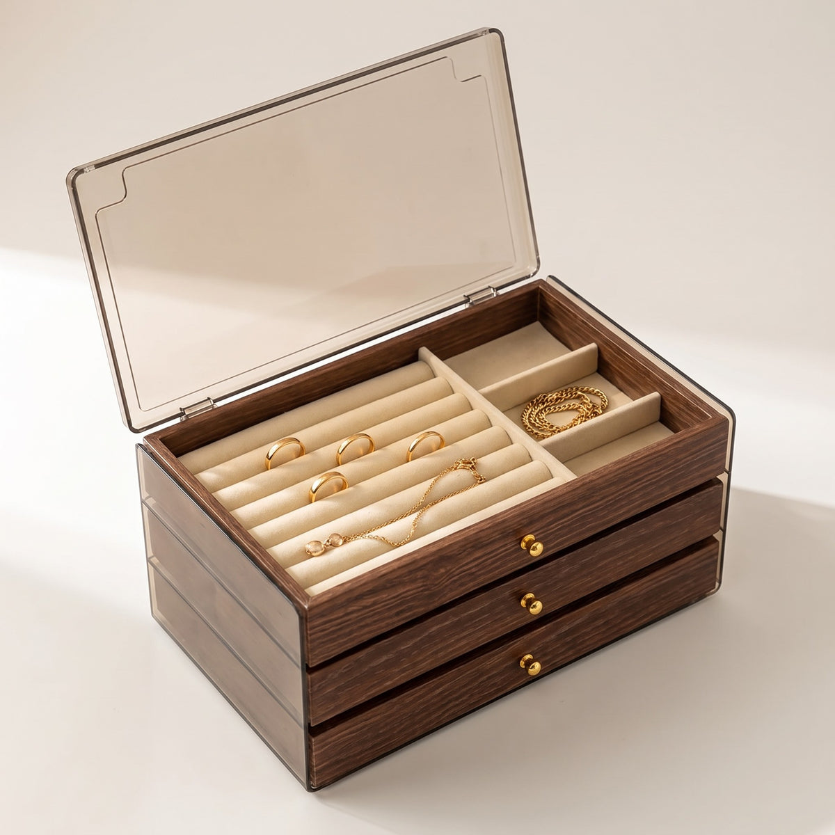 Warm Wood-Grain Tiered Jewelry Box with its clear lid lifted, showing padded ring rolls and open compartments in the top tray.