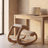 Ergonomic Rocking Kneeling Chair pulled up to a white oak desk at working height beside a warm plaster wall.