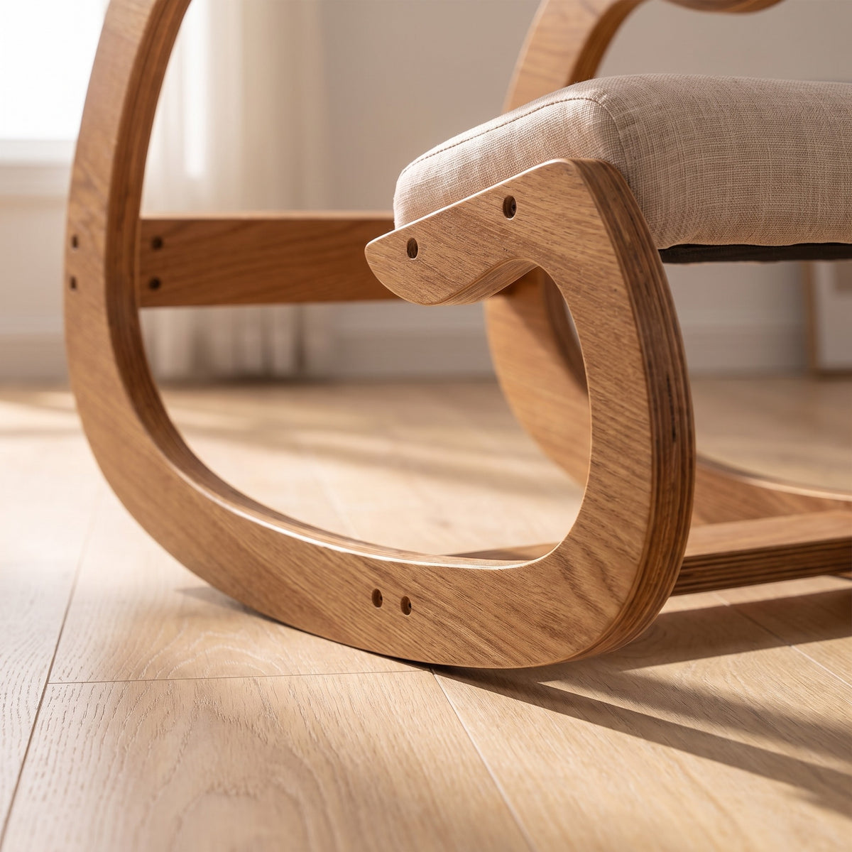 Low-angle view of the curved rocker runners of the Ergonomic Rocking Kneeling Chair resting on a pale oak floor.