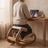 Person working at a desk while seated on the Ergonomic Rocking Kneeling Chair, seen from behind in a daylit room.