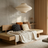Modern interior with wooden bed, pillows, and a large window.