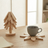 Mug resting on a tree-shaped wood coaster on a desk