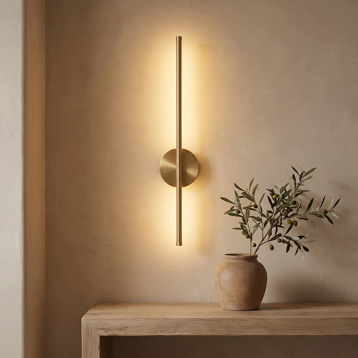 Wall bar lit above a white oak console, warm light on a plaster wall