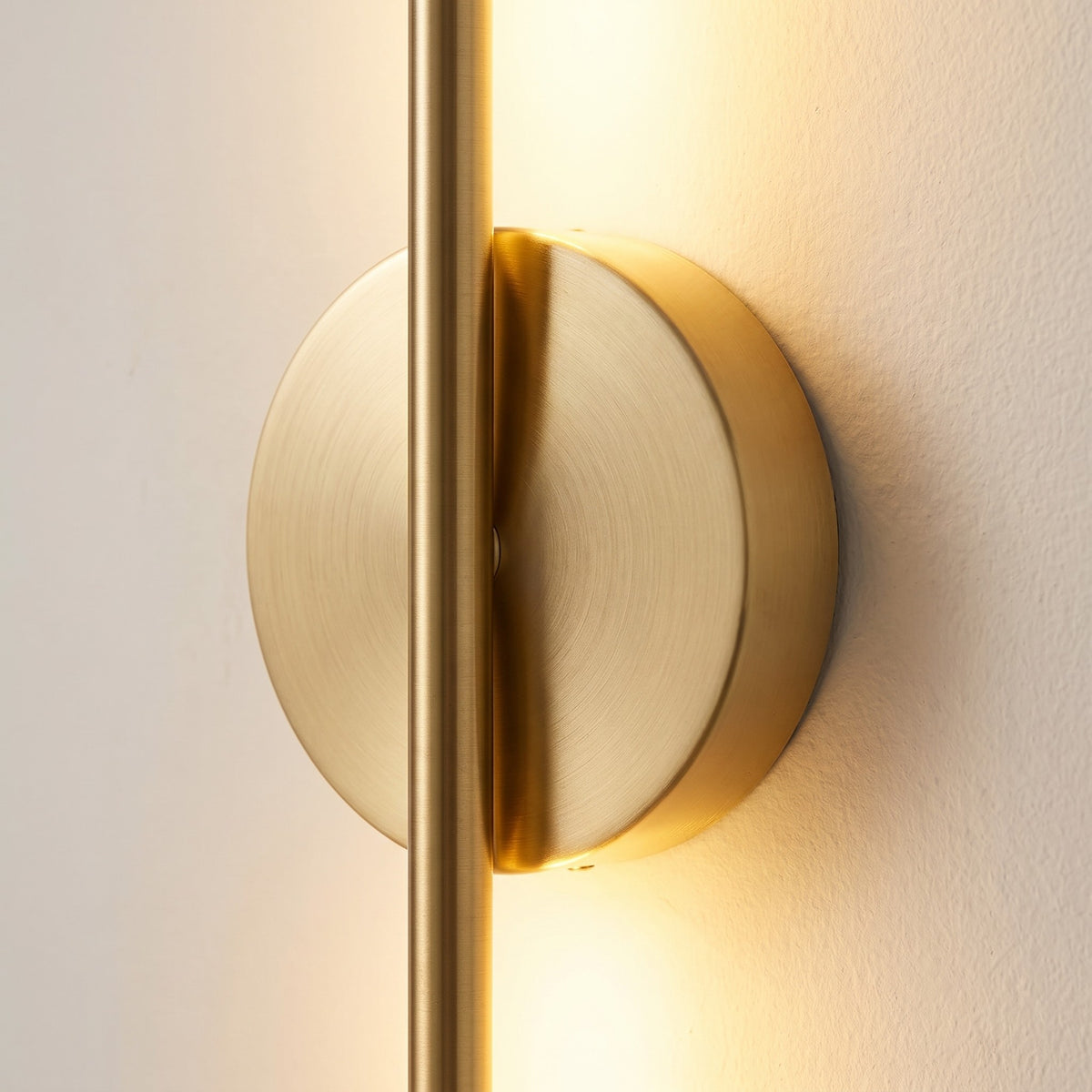 Close detail of the round magnetic wall plate where the wall bar crosses it