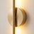 Close detail of the round magnetic wall plate where the wall bar crosses it