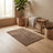 Khaki entry mat styled in a warm entryway scene